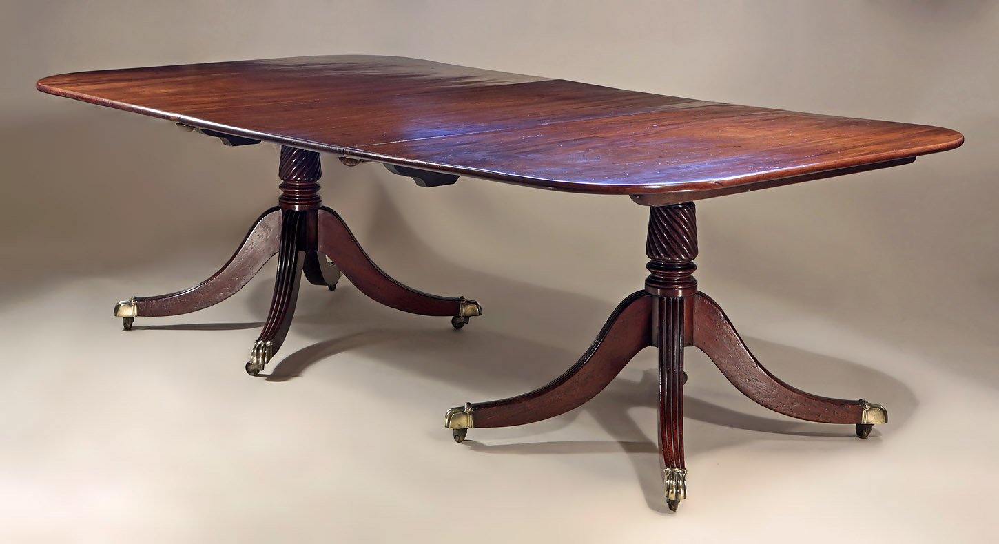 Fine George III Cuban Mahogany 2-Pedestal Dining Table, shown with one leaf from on oblique angie
